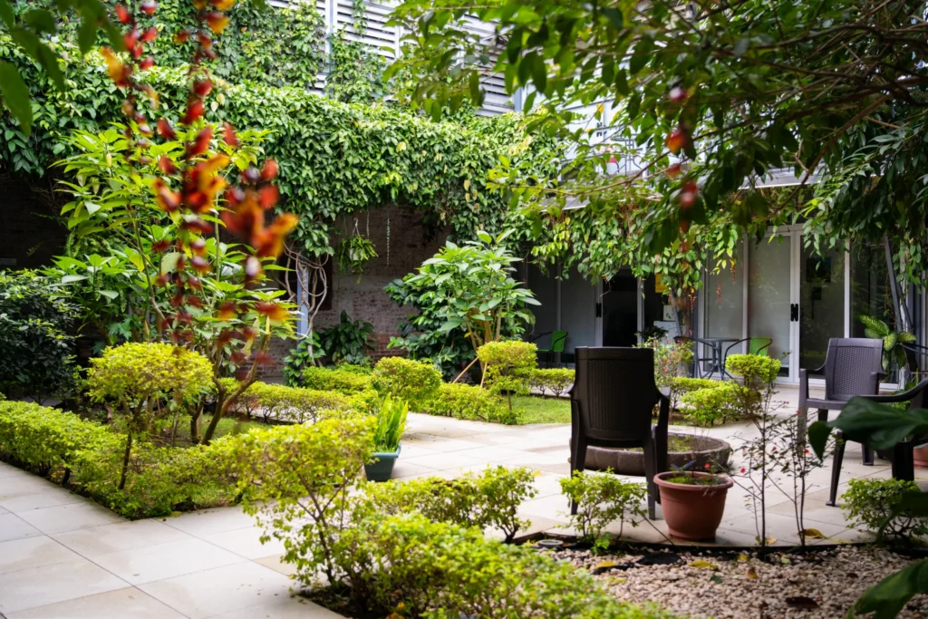 Interior garden patio with tropical plants and seating at Candó Living